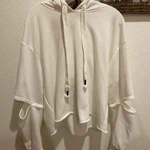 Hooded sweater with cut holes in sleeves